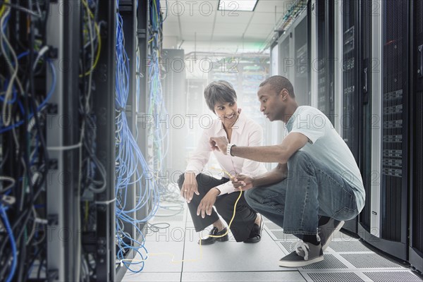 Business people working in server room