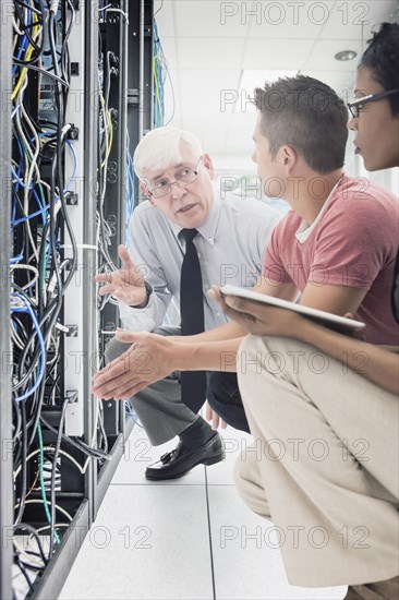 Business people working in server room