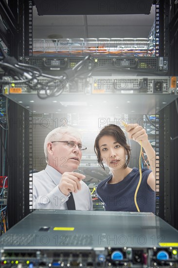 Business people working in server room