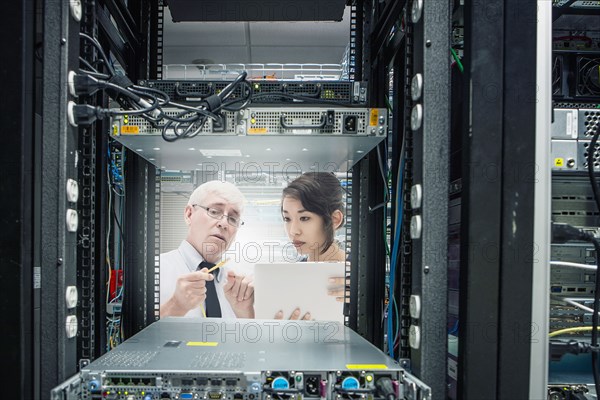 Business people working in server room