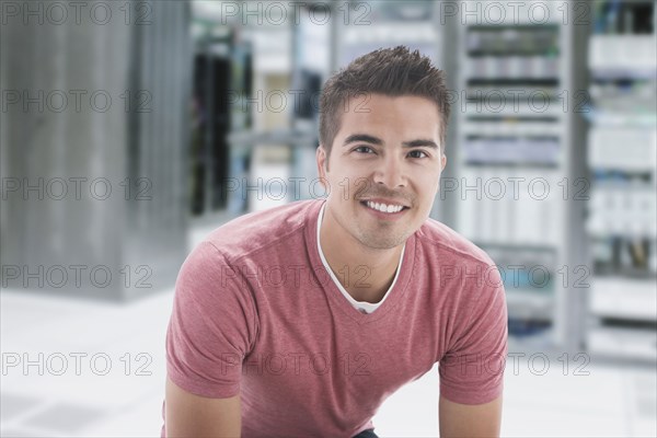 Mixed race businessman in server room