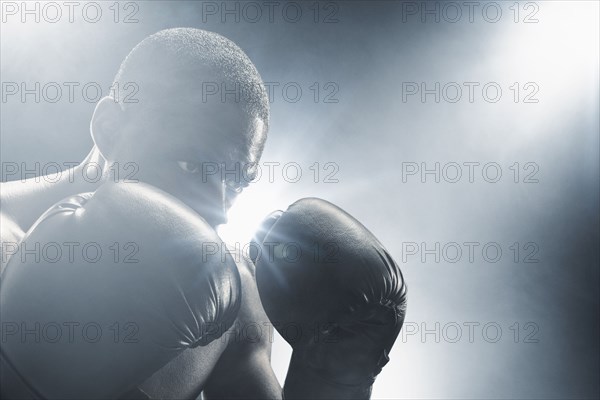 African American boxer with gloves raised