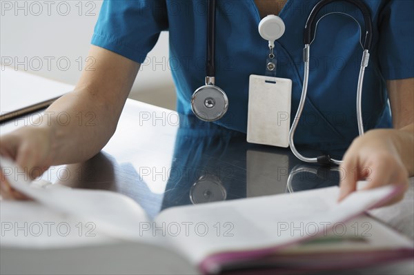 Caucasian surgeon reading book