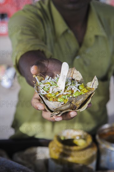 Hand holding bowl of food