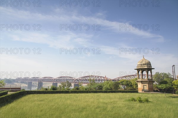 Green park and bridge under blue sky