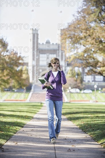 Caucasian student on cell phone on campus
