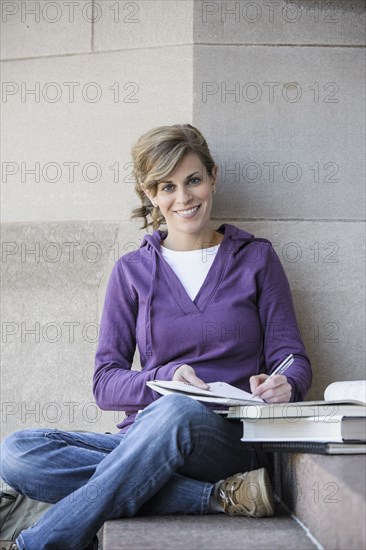 Caucasian student studying on campus