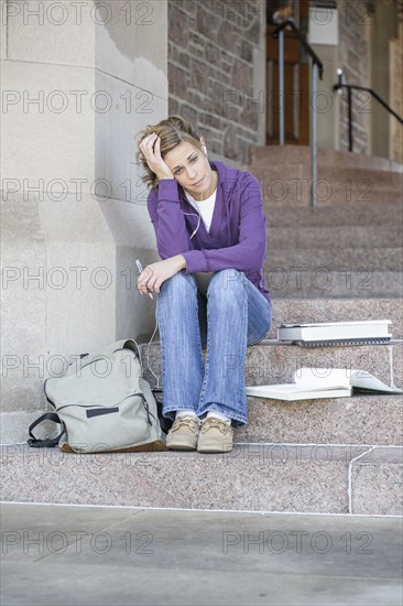 Caucasian student sitting on campus