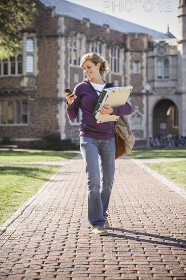 Caucasian student walking on campus