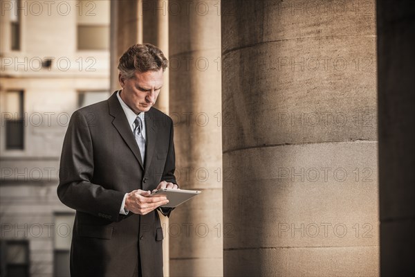 Caucasian businessman using tablet computer