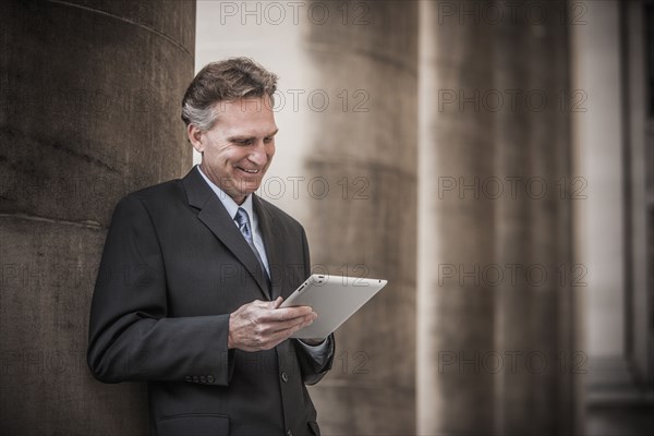 Caucasian businessman using tablet computer