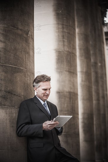 Caucasian businessman using tablet computer