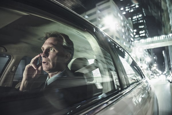 Caucasian man driving and talking on cell phone