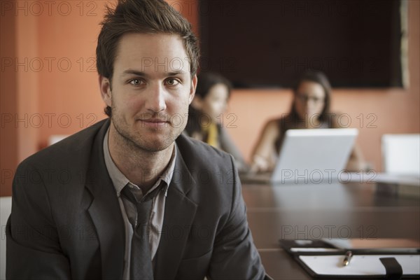 Caucasian businessman sitting at meeting table