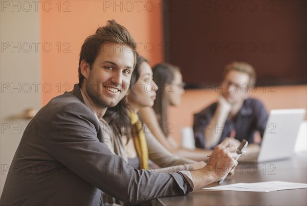 Caucasian businessman smiling in meeting