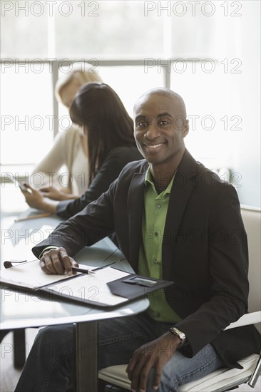 Black businessman smiling in meeting