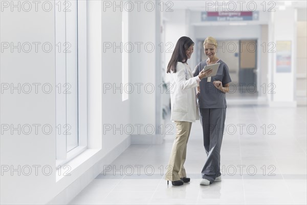 Doctor and nurse talking in hospital