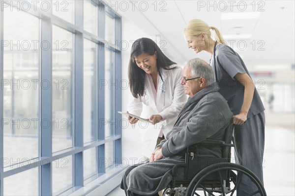 Doctor and nurse talking to patient in hospital