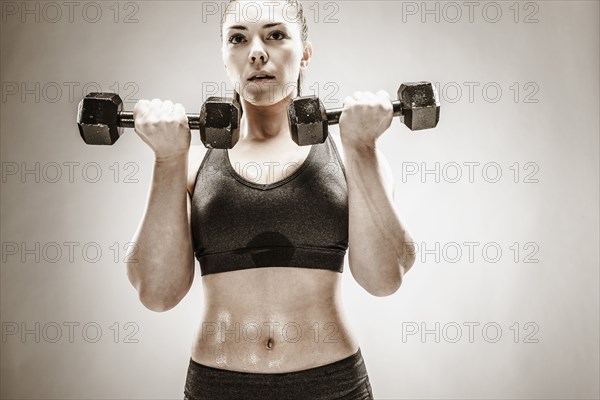 Caucasian woman lifting weights