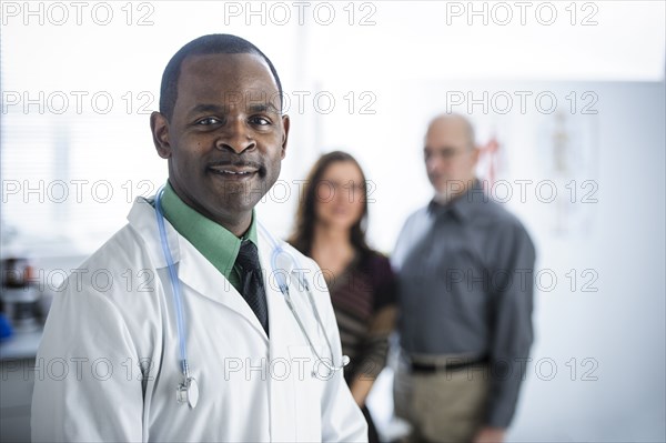 Doctor and patients standing in office