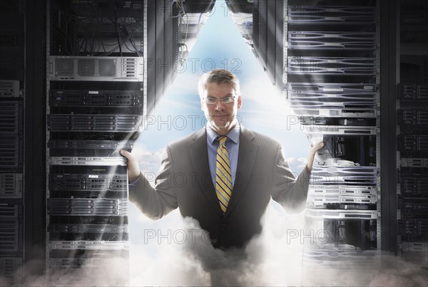 Caucasian businessman pulling back curtain to clouds