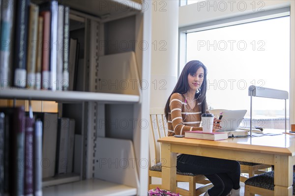 Student working at desk in library