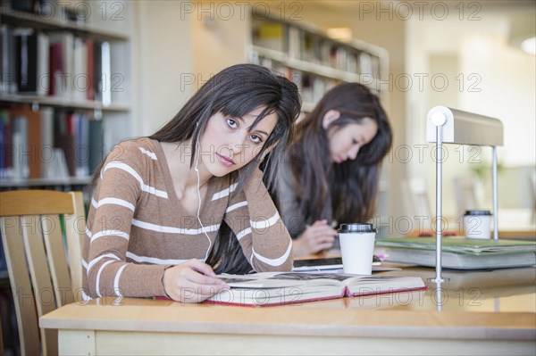 Students working at desk in library