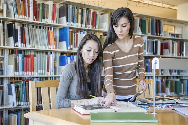 Students working at desk in library