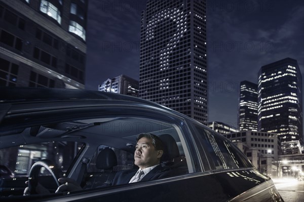 Pacific Islander businessman driving on city street