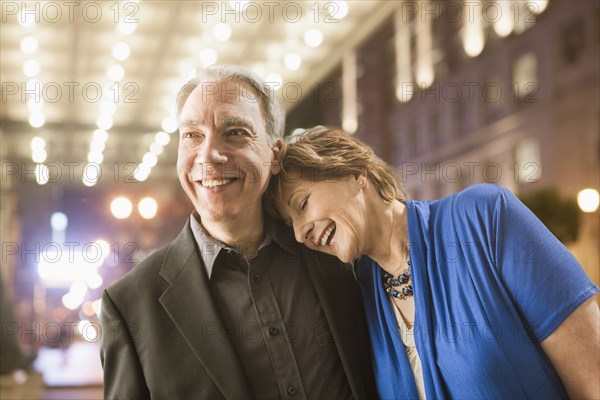 Caucasian couple walking on city street