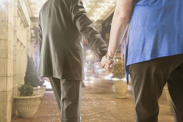 Caucasian couple holding hands outdoors