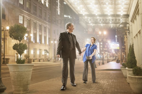 Caucasian couple holding hands outdoors