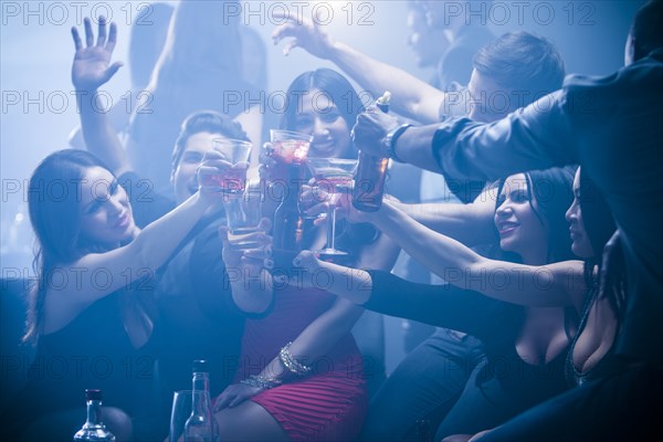 Friends toasting each other in nightclub
