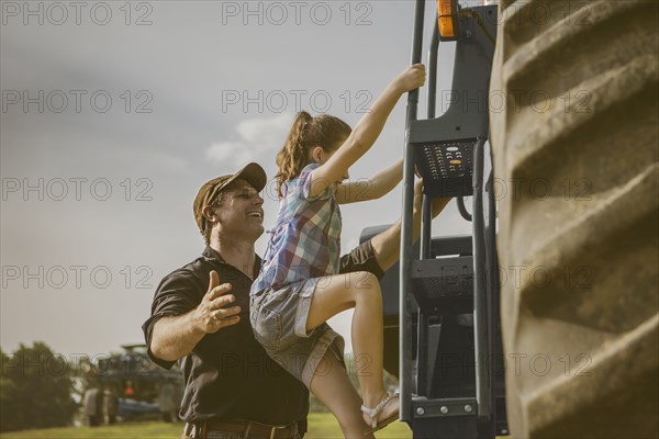 Caucasian father and daughter working on farm