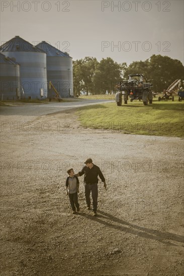 Caucasian father and son walking on farm