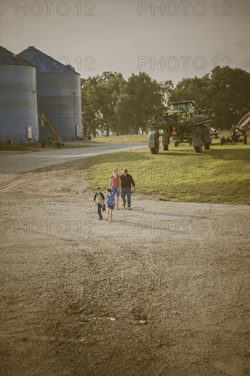 Caucasian family walking on farm