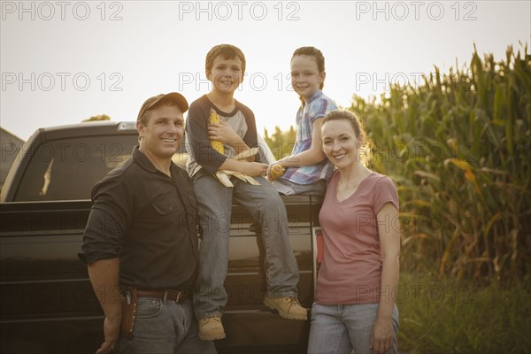 Caucasian family smiling on truck