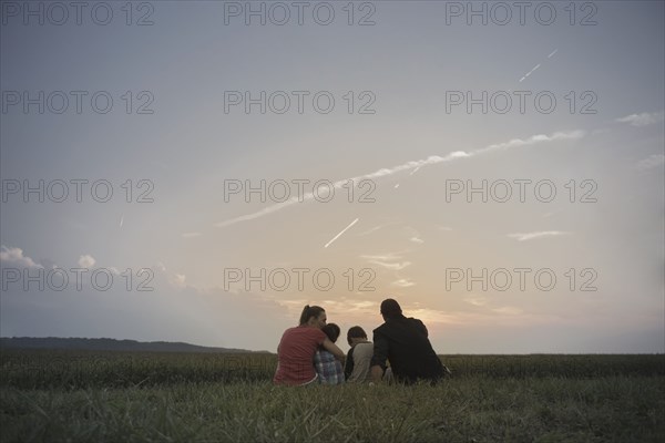 Caucasian family overlooking crop fields