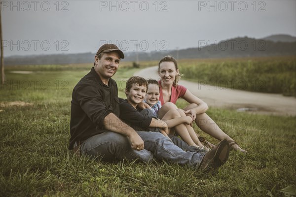 Caucasian family overlooking crop fields