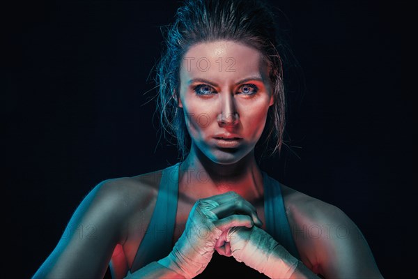 Caucasian boxer cracking her knuckles