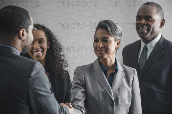 Business people shaking hands in meeting