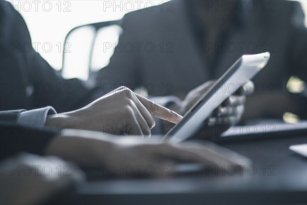 Businessman using digital tablet in meeting