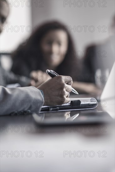 Businessman taking notes in meeting