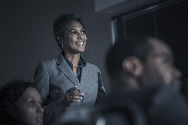 Business people watching audio visual presentation in meeting