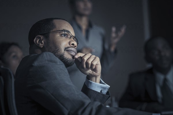 Business people watching projection in meeting