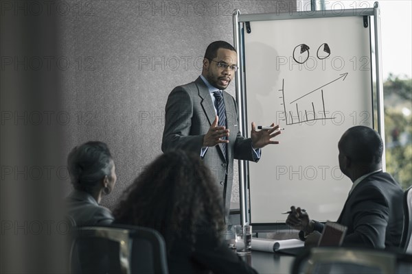 Businessman talking to colleagues in meeting