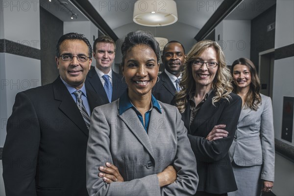 Business people smiling in office corridor