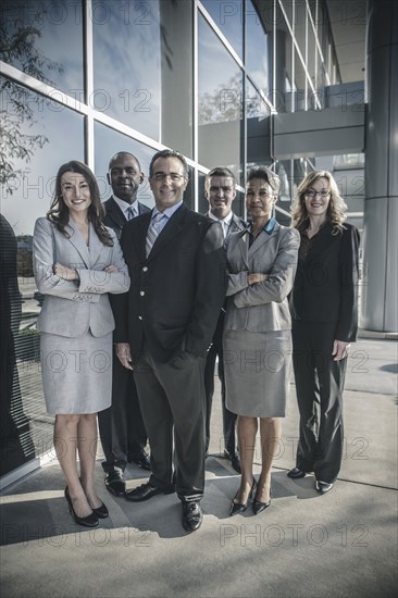 Business people smiling outside office building