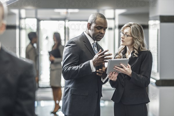 Business people using digital tablet in office