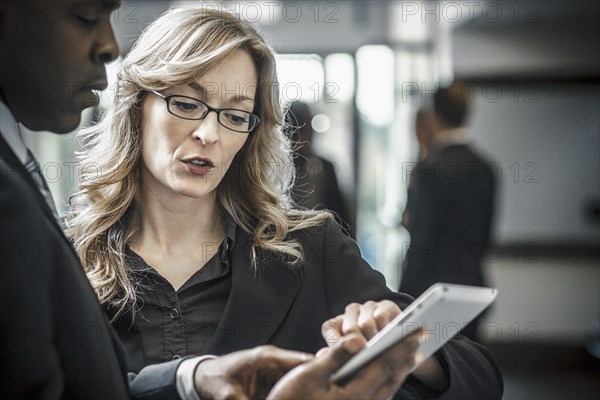 Business people using digital tablet in office